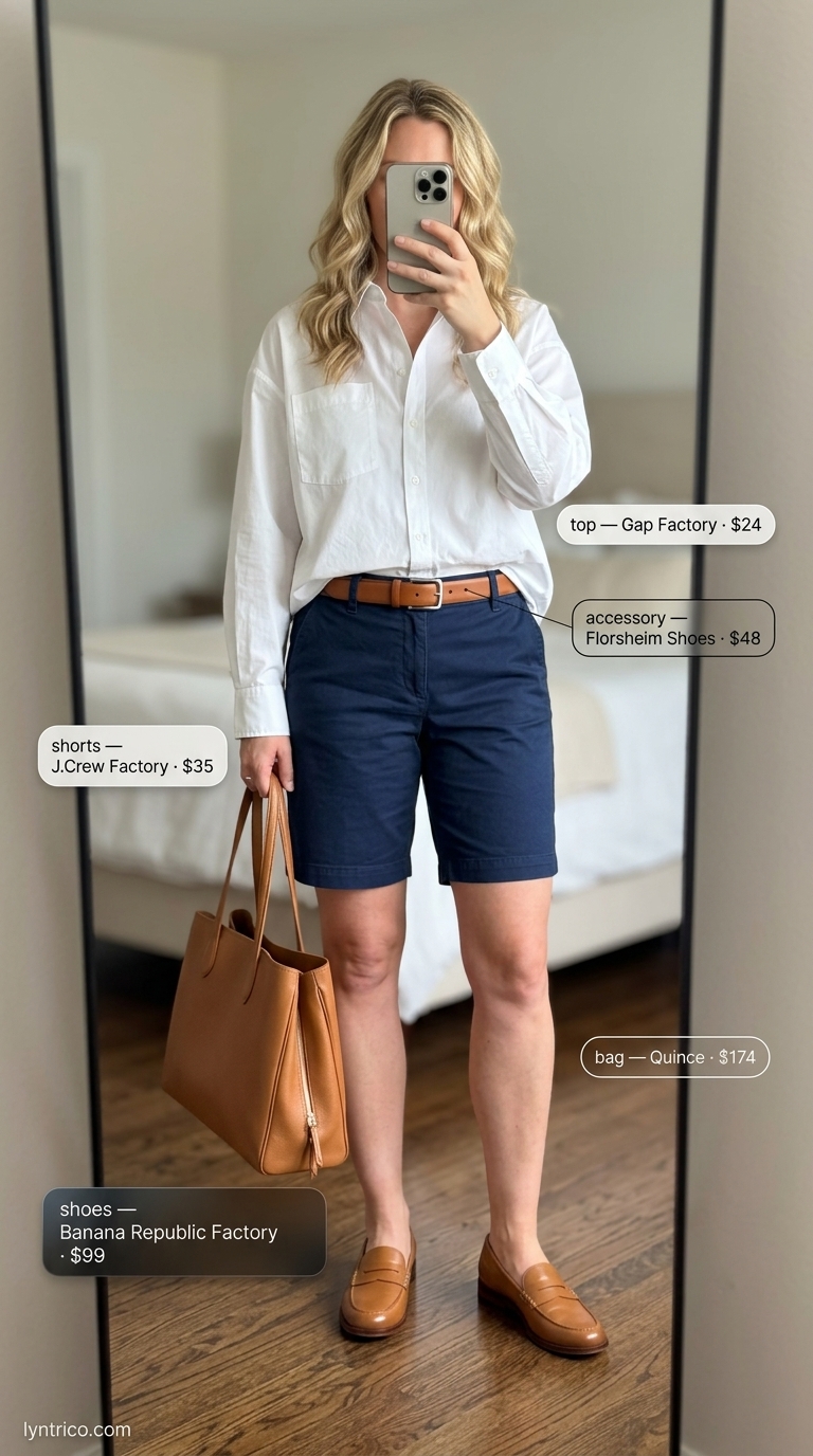 Chic minimalist summer outfit 2026: White oversized shirt, navy tailored shorts, tan loafers, belt, and tote for brunch.