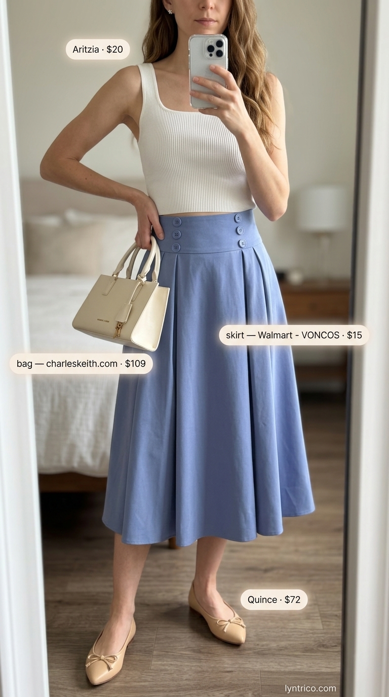 Neutral quiet luxury summer outfits for women 2026: Blue pleated skirt, white knit top, nude flats.