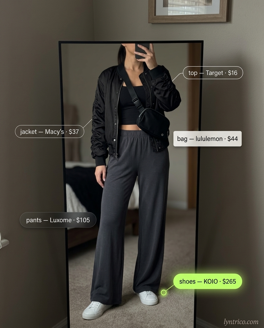 Elevated athleisure summer outfit for women with brunette hair 2026: charcoal grey wide-leg pants, black tank, bomber jacket, sneakers.