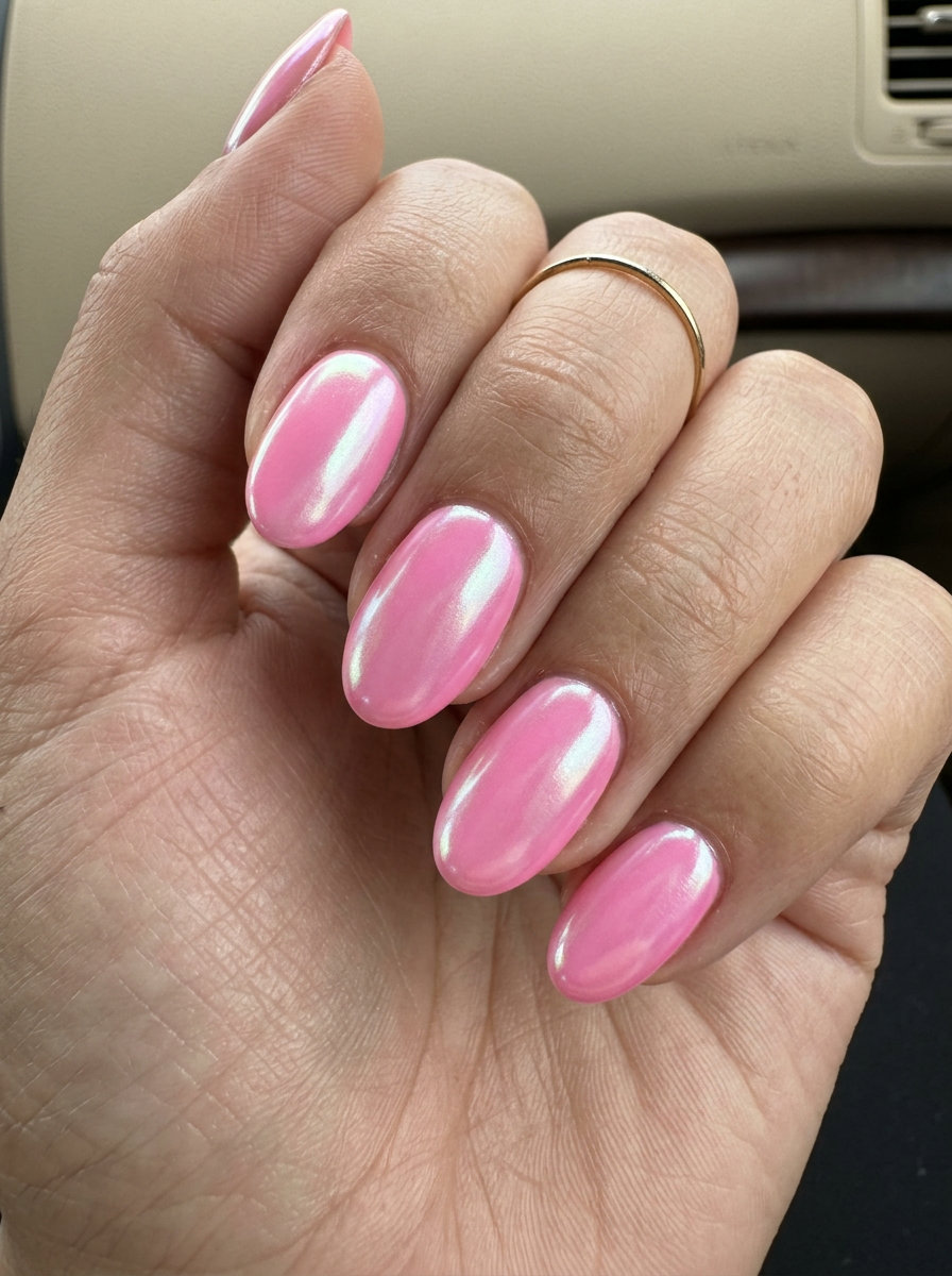Bubblegum pink glazed oval nails with iridescent chrome shift for parties. Oval summer nails 2026.