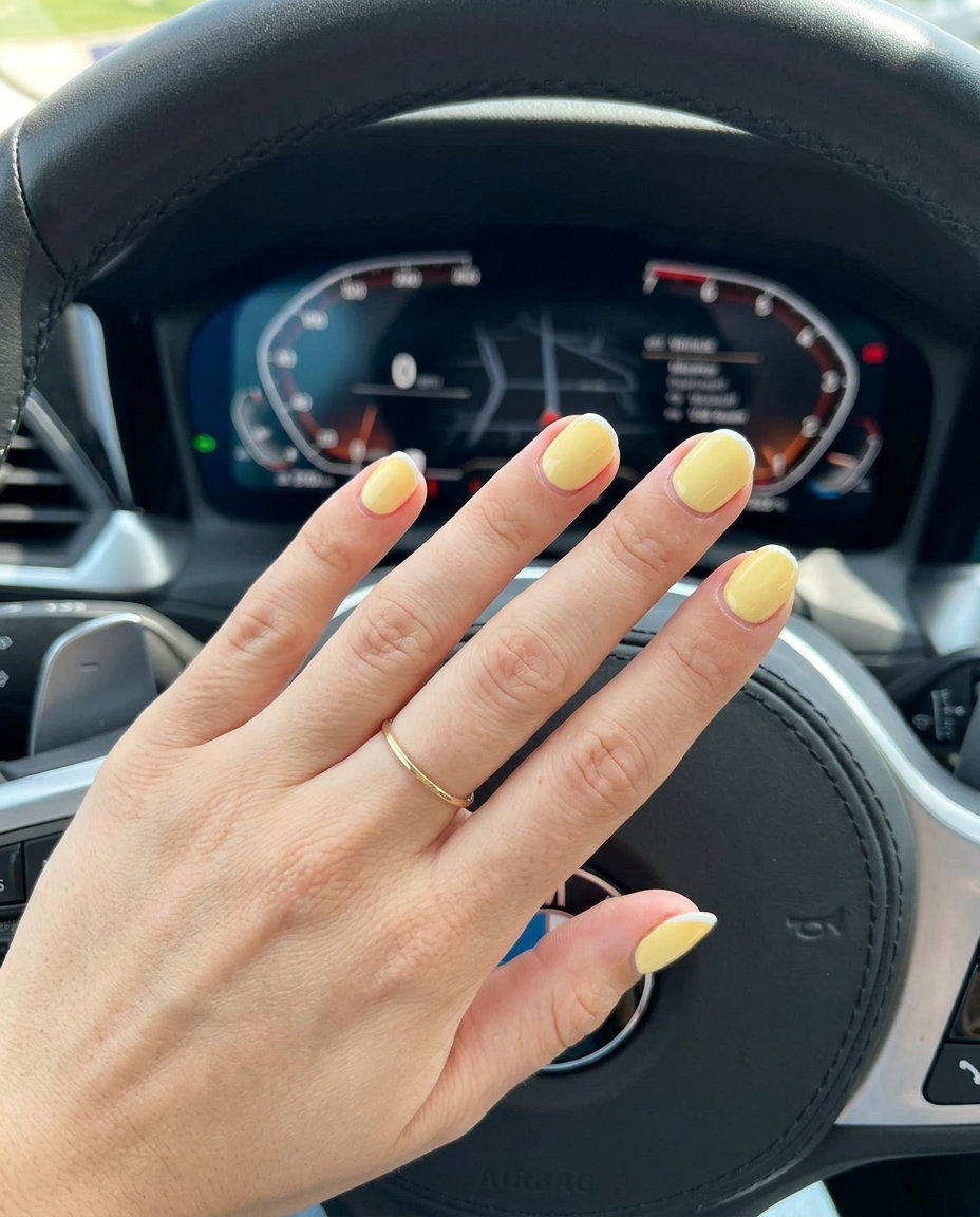 Short round summer nails 2026: Butter yellow micro French tip for casual brunch. Elegant & clean.