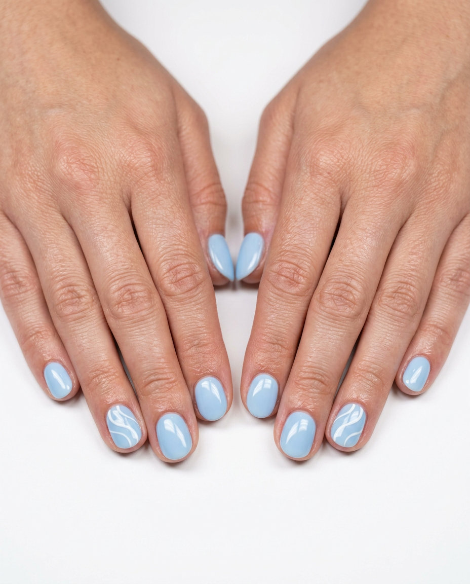 Short round summer nails 2026 in milky sky blue with white swirls. Minimalist, calm, and chic for office wear.