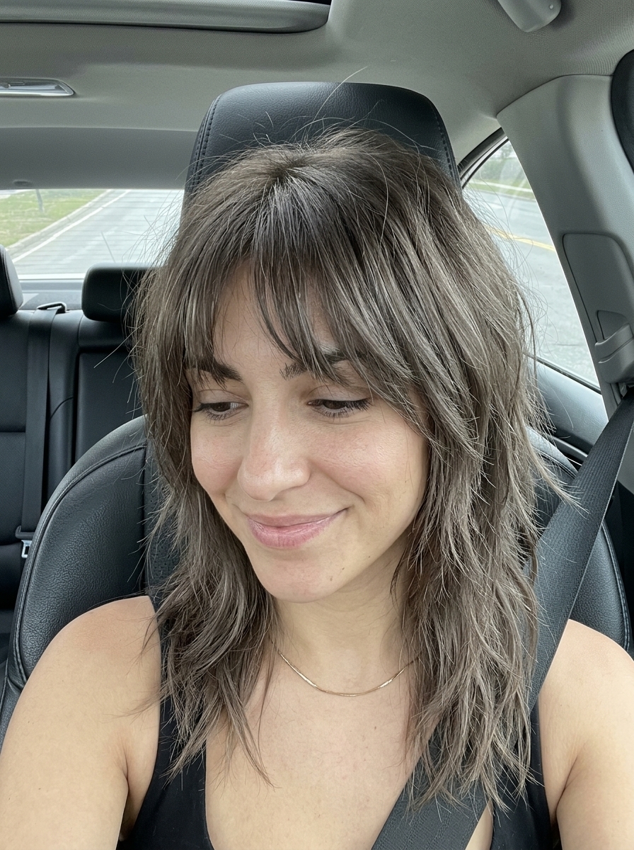 long ash brown wolf cut with smoky dimension and wispy bangs for edgy look