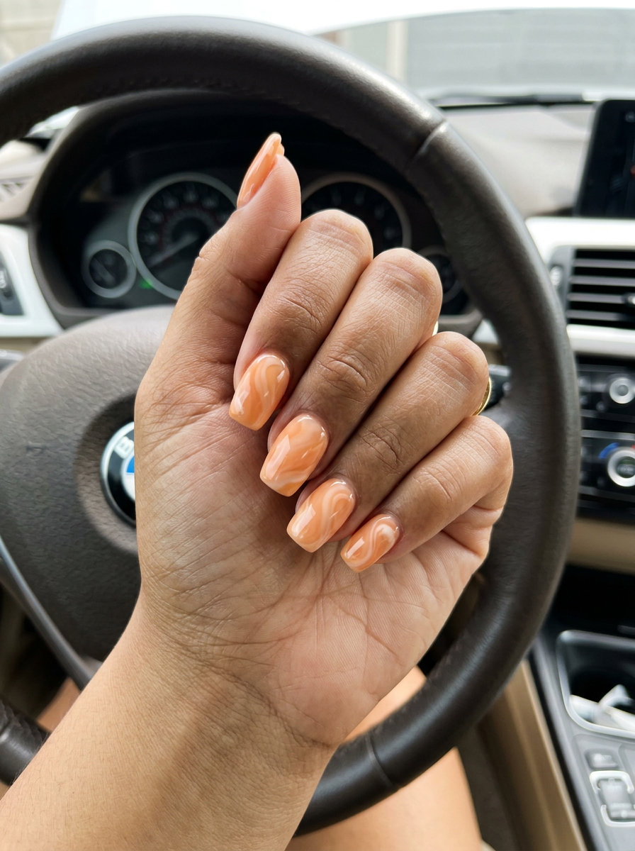 Peachy swirl milky squoval nails for summer fruits nail art 2026. Creamy peach, soft white, elegant.