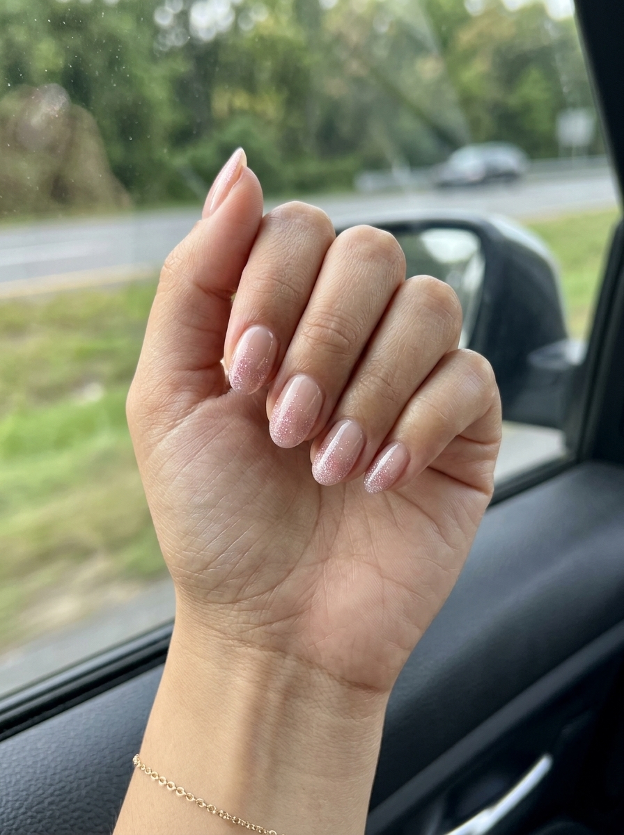 Blushing Glitter Gradient nails with sheer nude and soft pink holographic glitter for summer 2026.