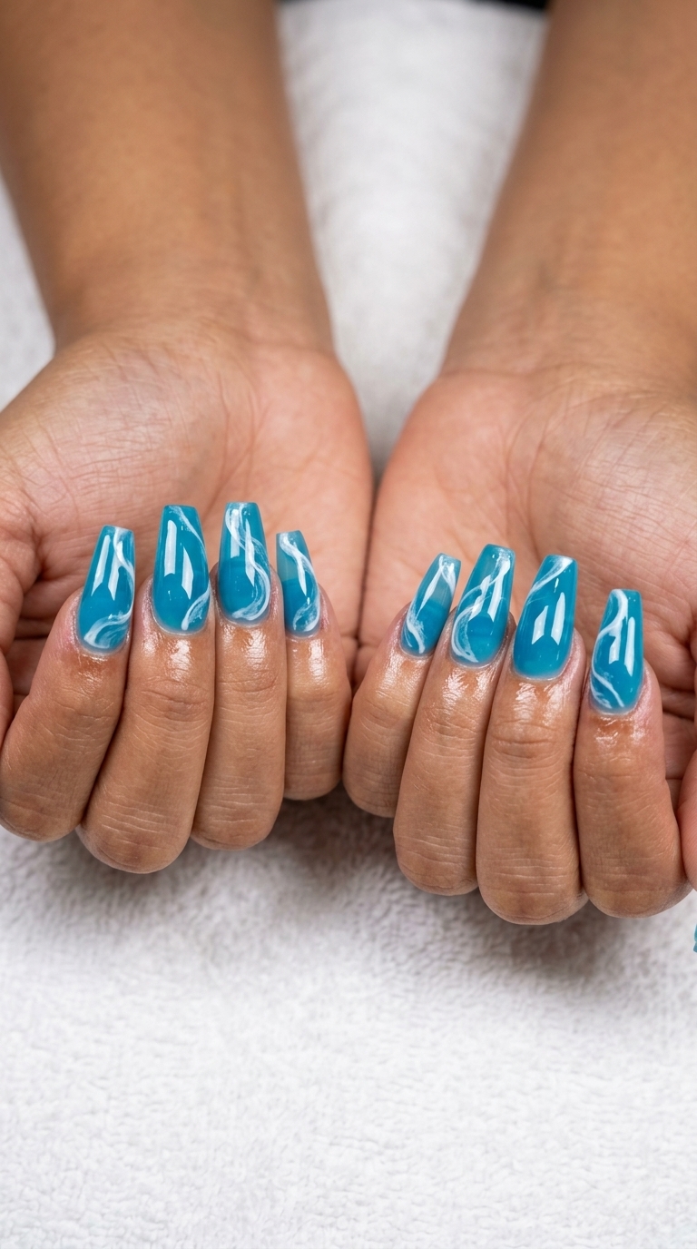 Ocean Swirl Jelly Nails for summer holiday nails 2026: translucent ocean blue with opaque white swirls on coffin shape.
