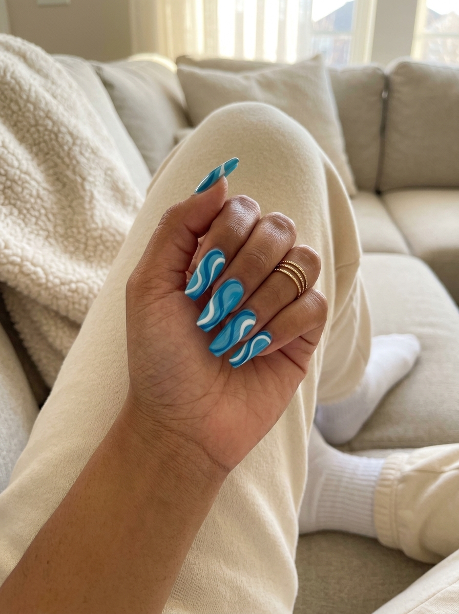 Oceanic Abstract Swirls Nails for summer holiday nails 2026: vibrant blue and white swirls with a matte finish.