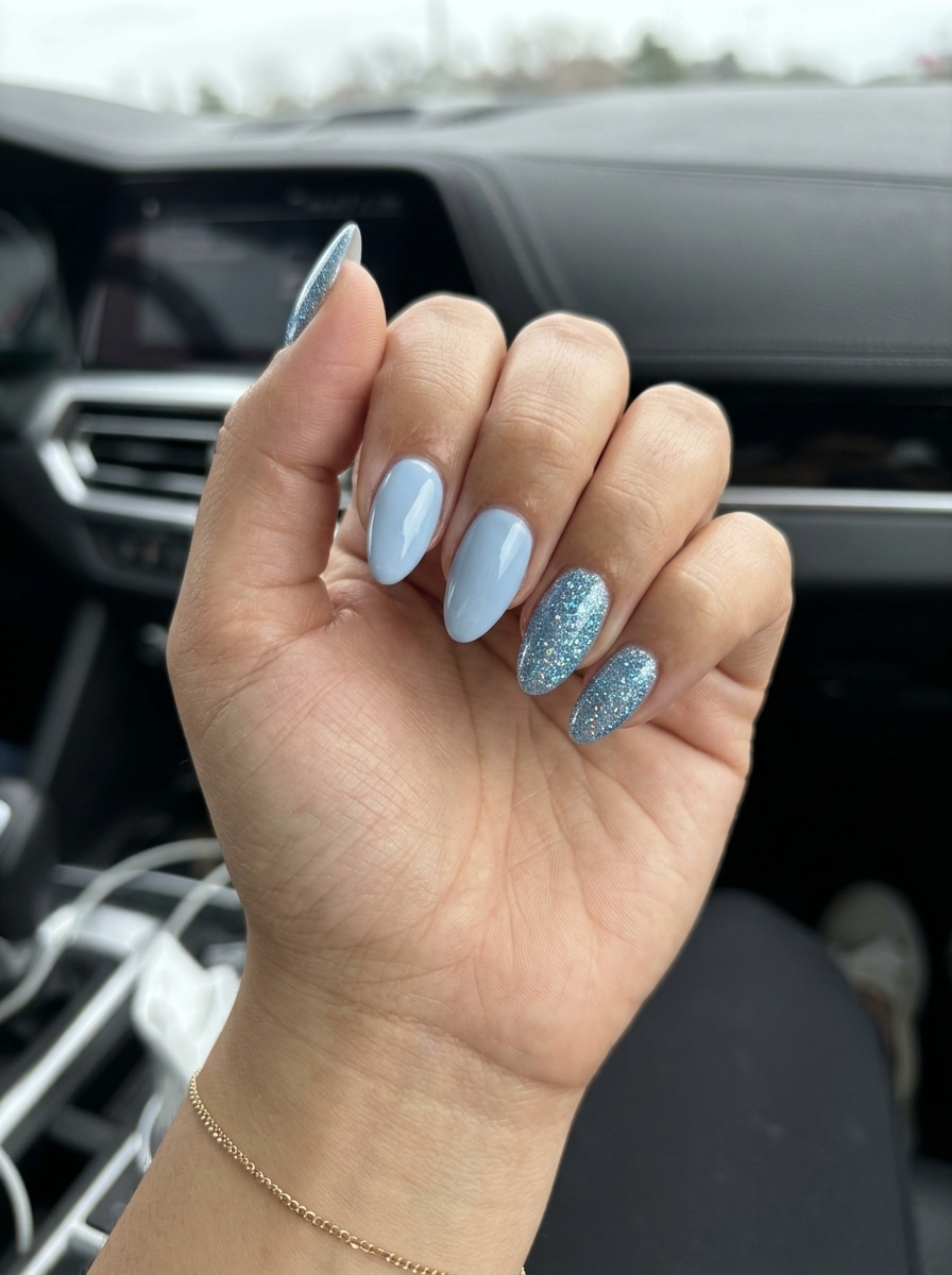 Sky Sparkle Pastel Blue Nails 2026: Opaque pastel blue with fine blue glitter accents on long coffin nails for vacation.