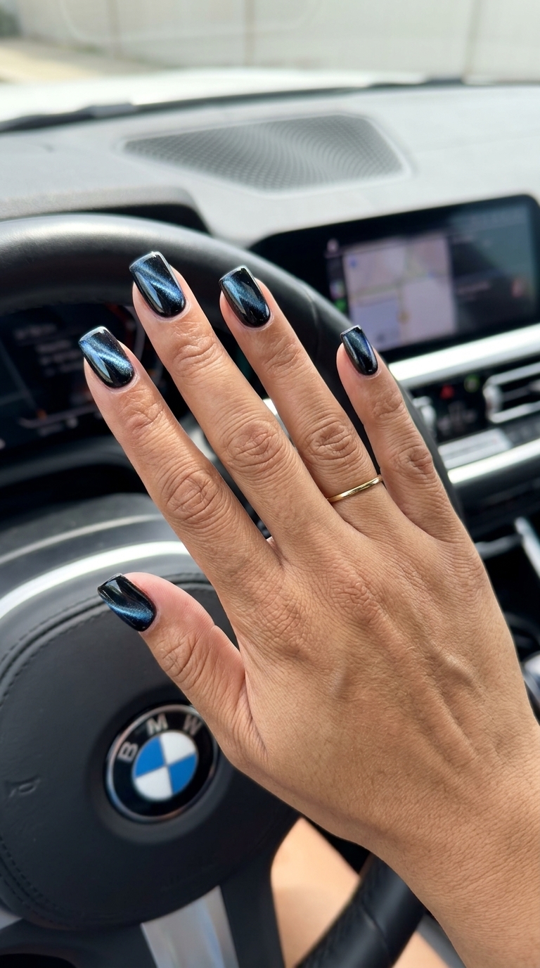 Cybernetic Cat-Eye Square: Trending summer nails 2026 in deep black with electric blue/silver shift for parties.