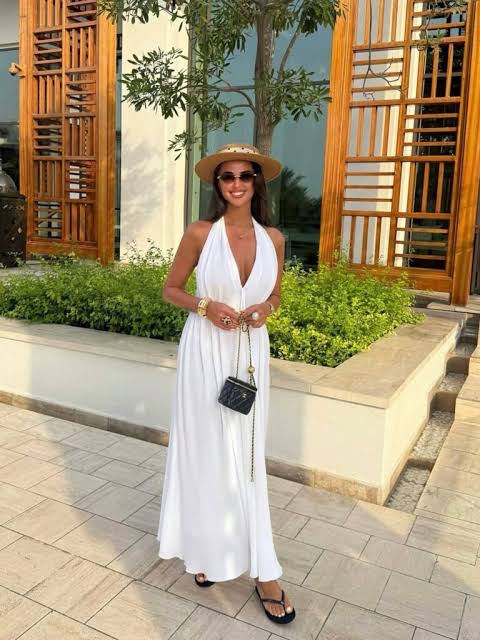 Flowy White Halter Maxi Dress with Wide-Brimmed Hat Flowy White Halter Maxi Dress with Wide-Brimmed Hat — Vacation Outfits