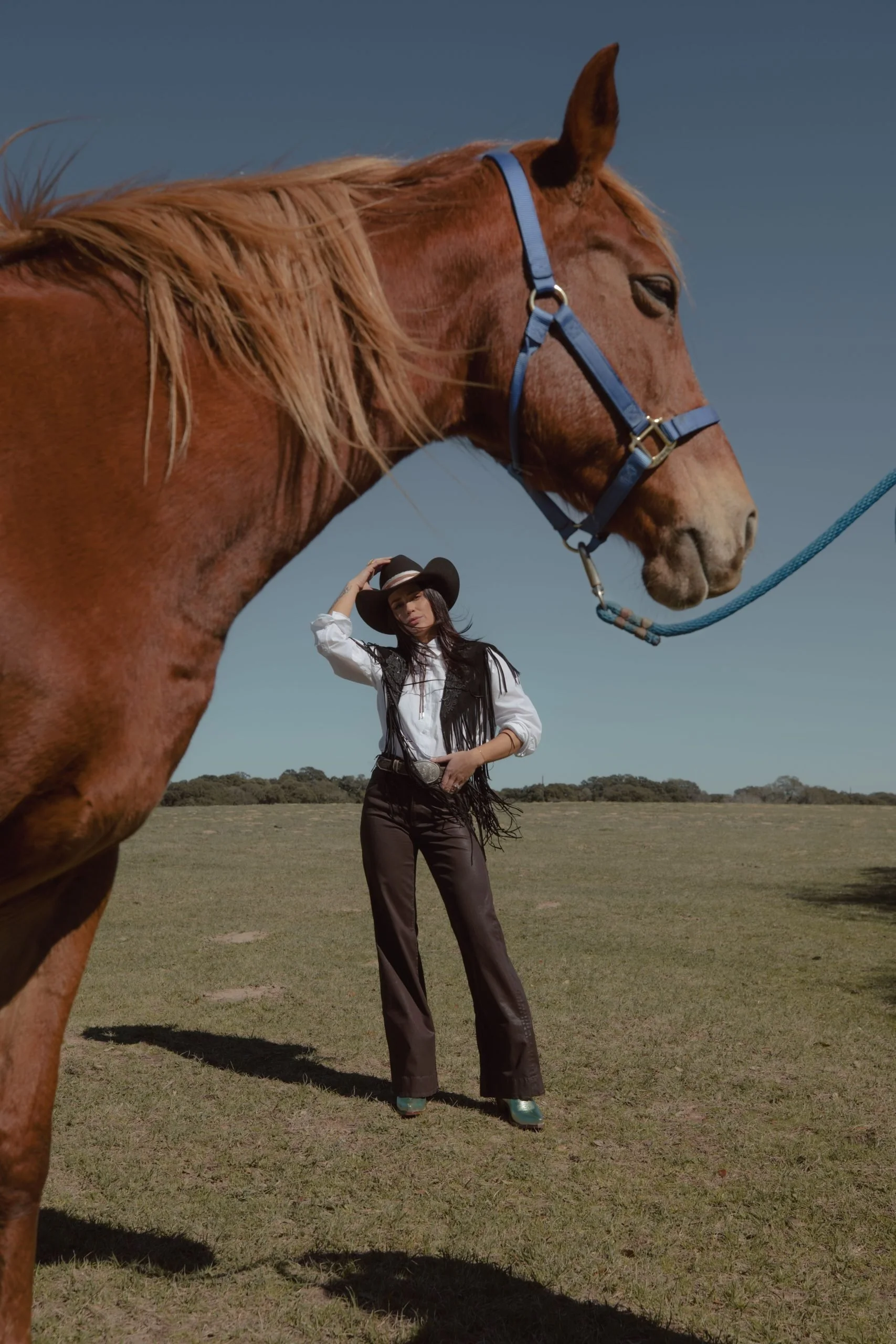 Fringed Black Vest Over White Shirt with Teal Pointed-Toe Boots — Rodeo Outfits