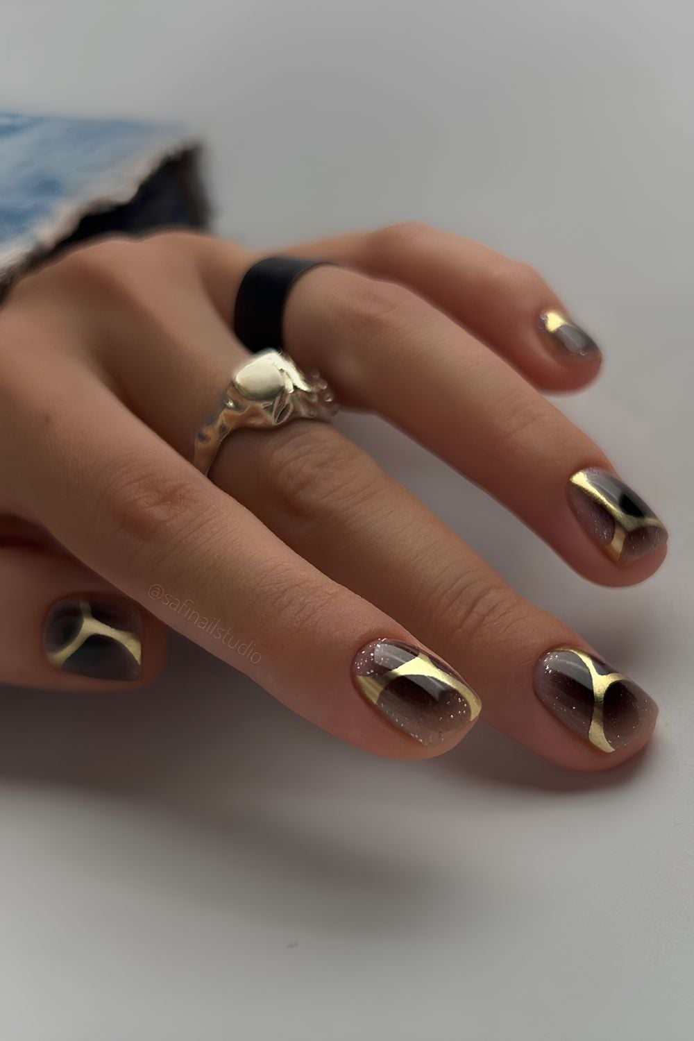 Short Square with Nude Base, Black Tips, and Gold Foil Accents — Black and Gold Nails