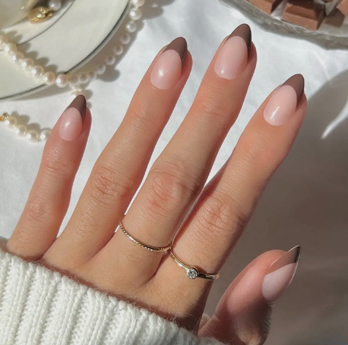 Sheer Pink with Deep Brown French Tips Sheer Pink with Deep Brown French Tips — Short Almond Nails