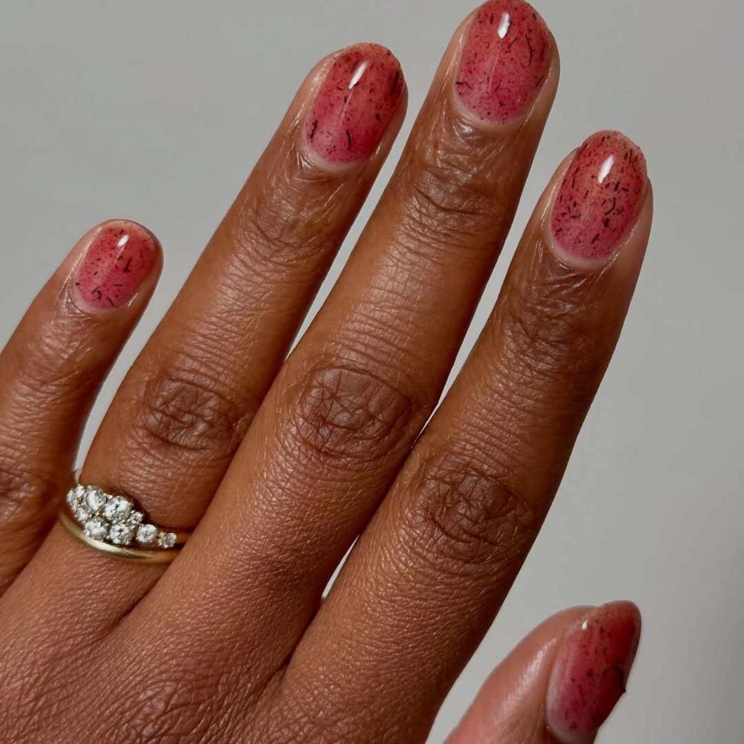 Sheer Pink With Speckled Red And Black — Very Short Nails