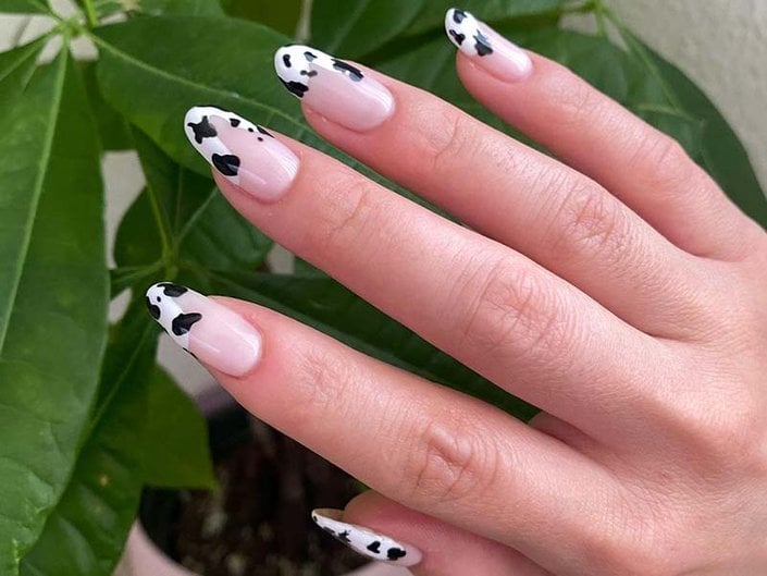 Glossy Nude Base French Tips with Cow Print Accents Glossy Nude Base French Tips with Cow Print Accents — Cow Print Nails