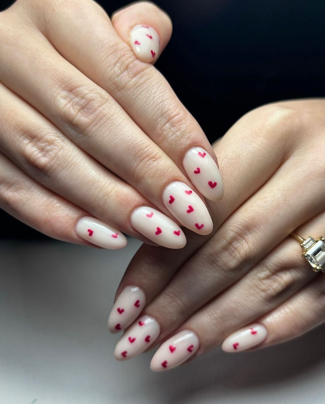 Medium Almond Nude With Scattered Red Hearts Medium Almond Nude With Scattered Red Hearts — Heart Nails