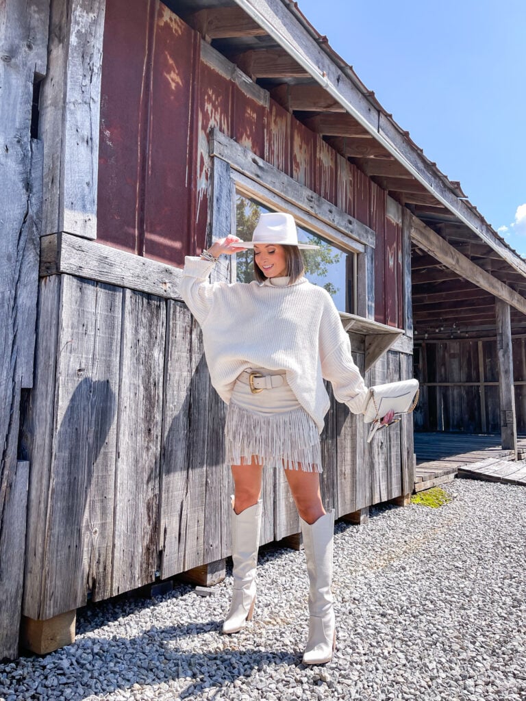 Oversized Turtleneck with Fringe Mini Skirt and Knee-High Boots Oversized Turtleneck with Fringe Mini Skirt and Knee-High Boots — Country Concert Outfits