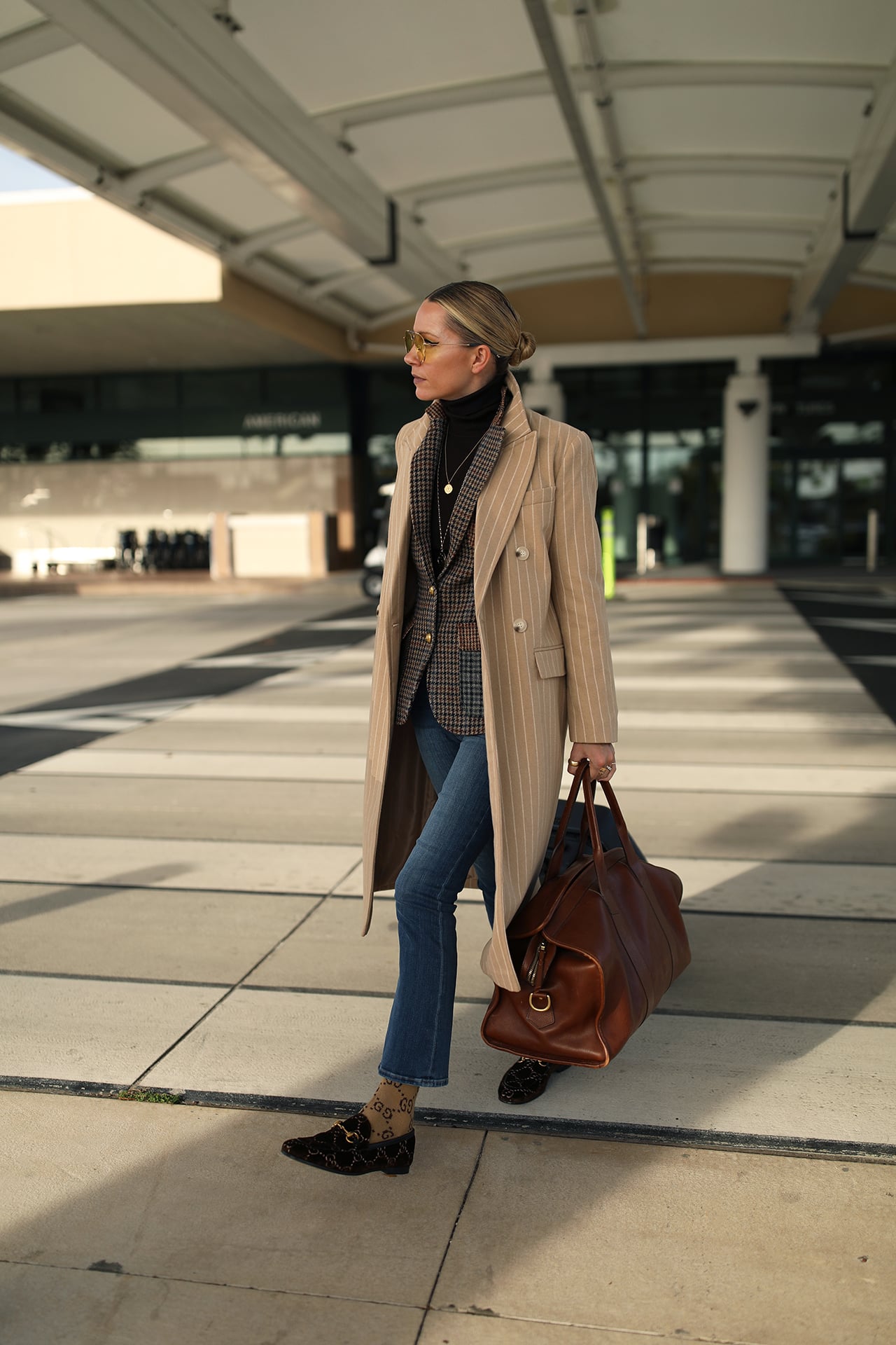 Pinstripe Trench Coat Layers Over Plaid for a Sophisticated Travel Look — Airport Outfits