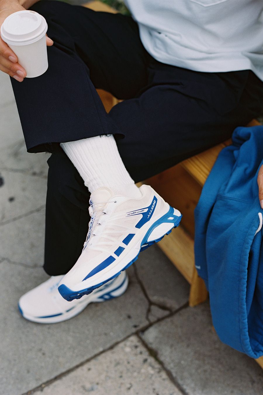 Athletic Casual: Navy Trousers and White Top with Blue Accent Salomon Sneakers Athletic Casual: Navy Trousers and White Top with Blue Accent Salomon Sneakers — Salomon Outfits
