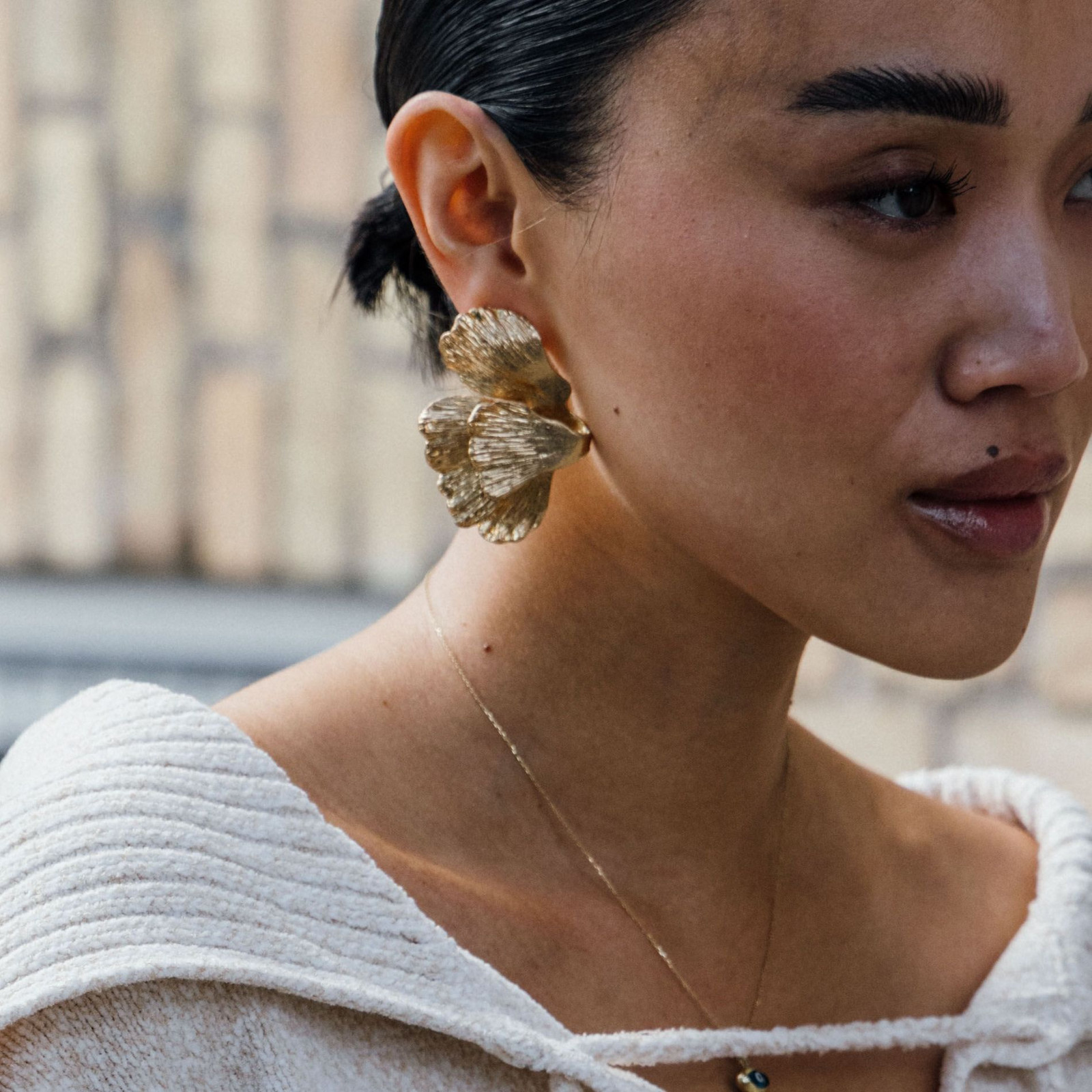 Sculptural Gold Flower Earrings with an Off-the-Shoulder Knit Top Sculptural Gold Flower Earrings with an Off-the-Shoulder Knit Top — Statement Earrings Outfits