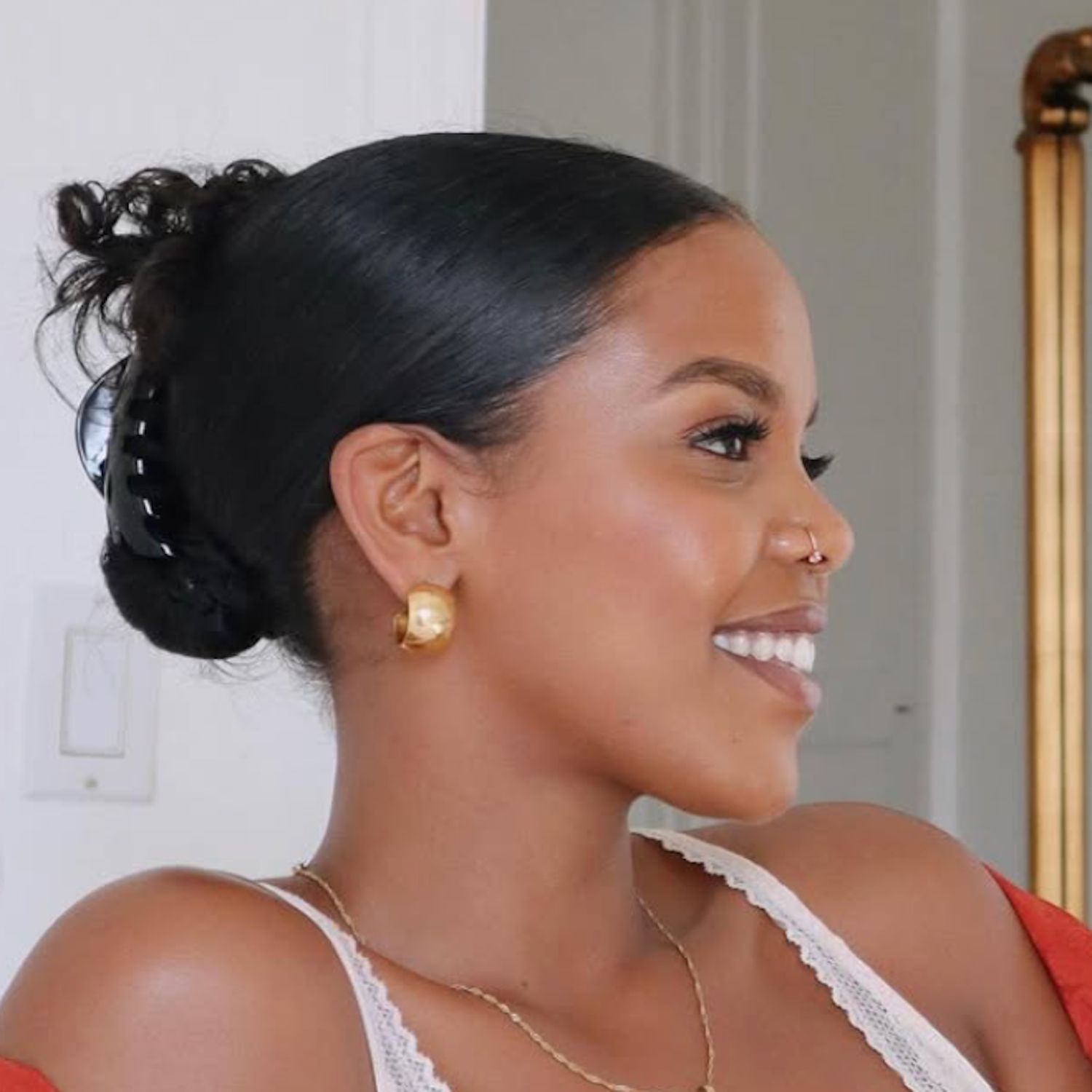 Slicked Black Bun With Tendrils — Claw Clip Hairstyles