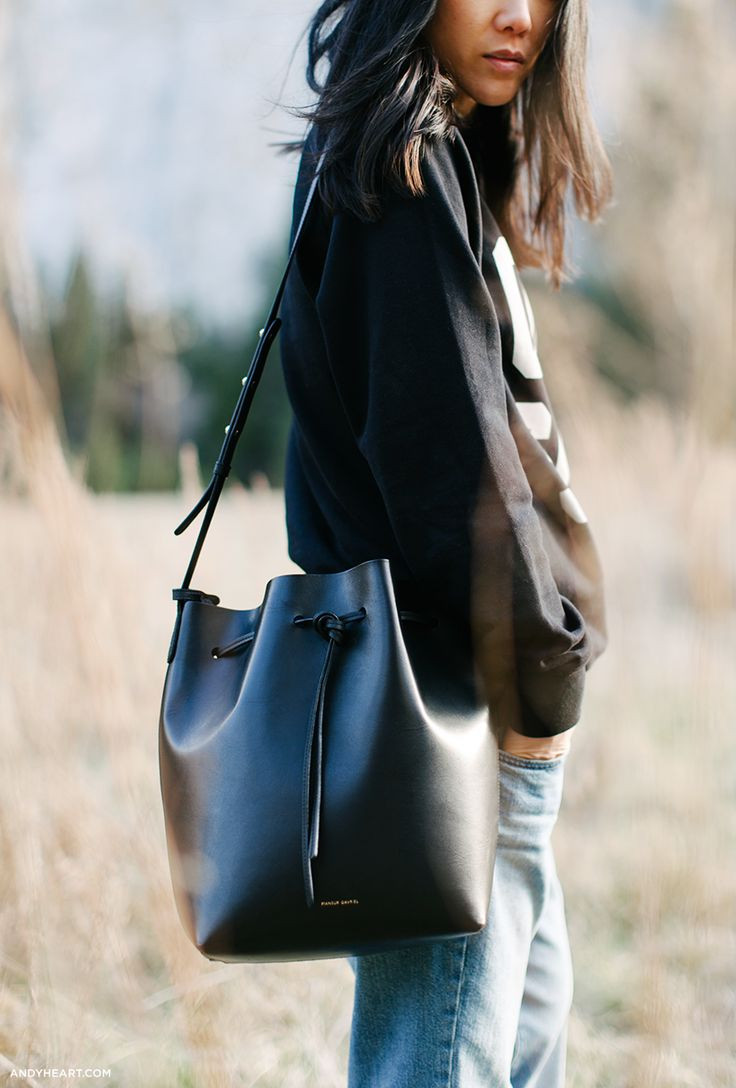 Edgy Street Style: Black Leather Bucket Bag with Ripped Denim — Bucket Bag Outfits