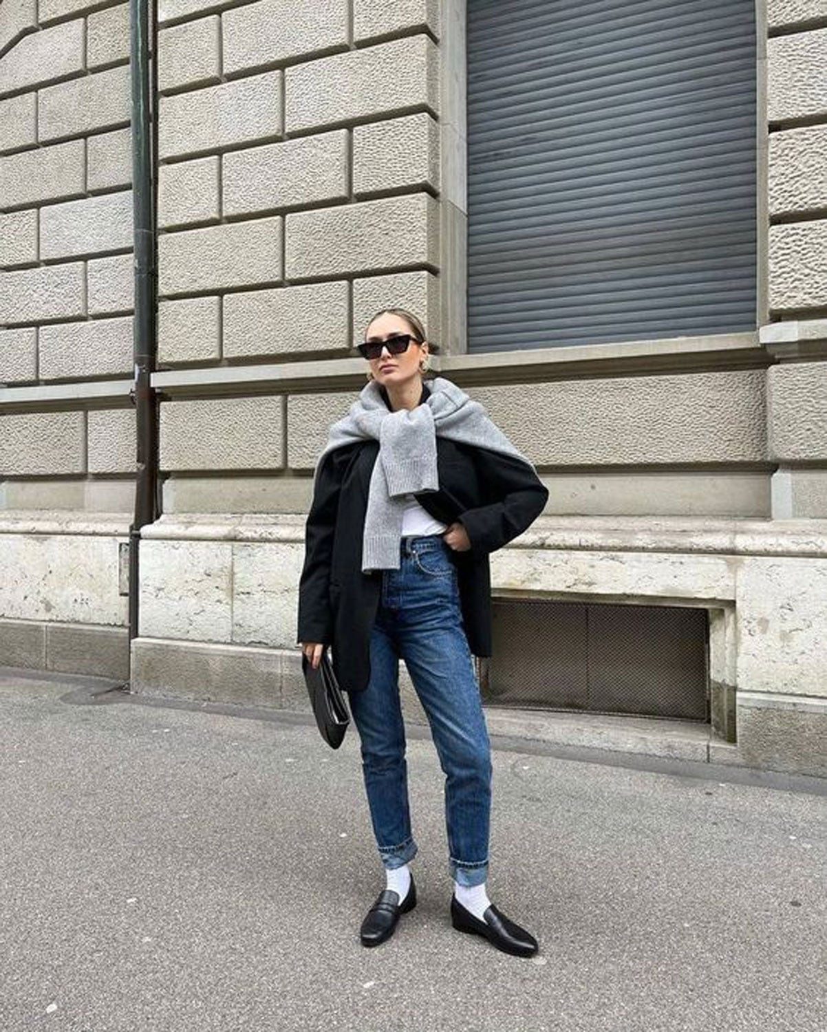 Smart Casual Layering: Black Loafers with White Socks, Jeans, and Draped Sweater Smart Casual Layering: Black Loafers with White Socks, Jeans, and Draped Sweater — Socks with Loafers Outfits