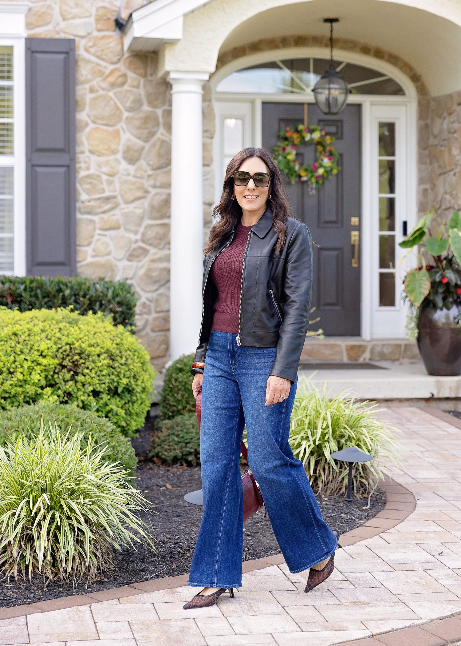 Dark Blue Wide Leg Jeans with a Leather Jacket and Leopard Heels