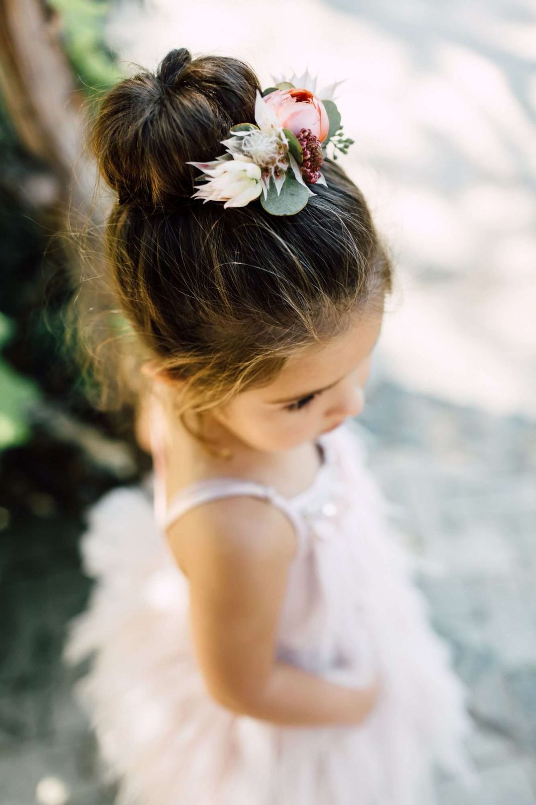 Neat Bun With Floral Accessory Neat Bun With Floral Accessory — Flower Girl Hairstyles