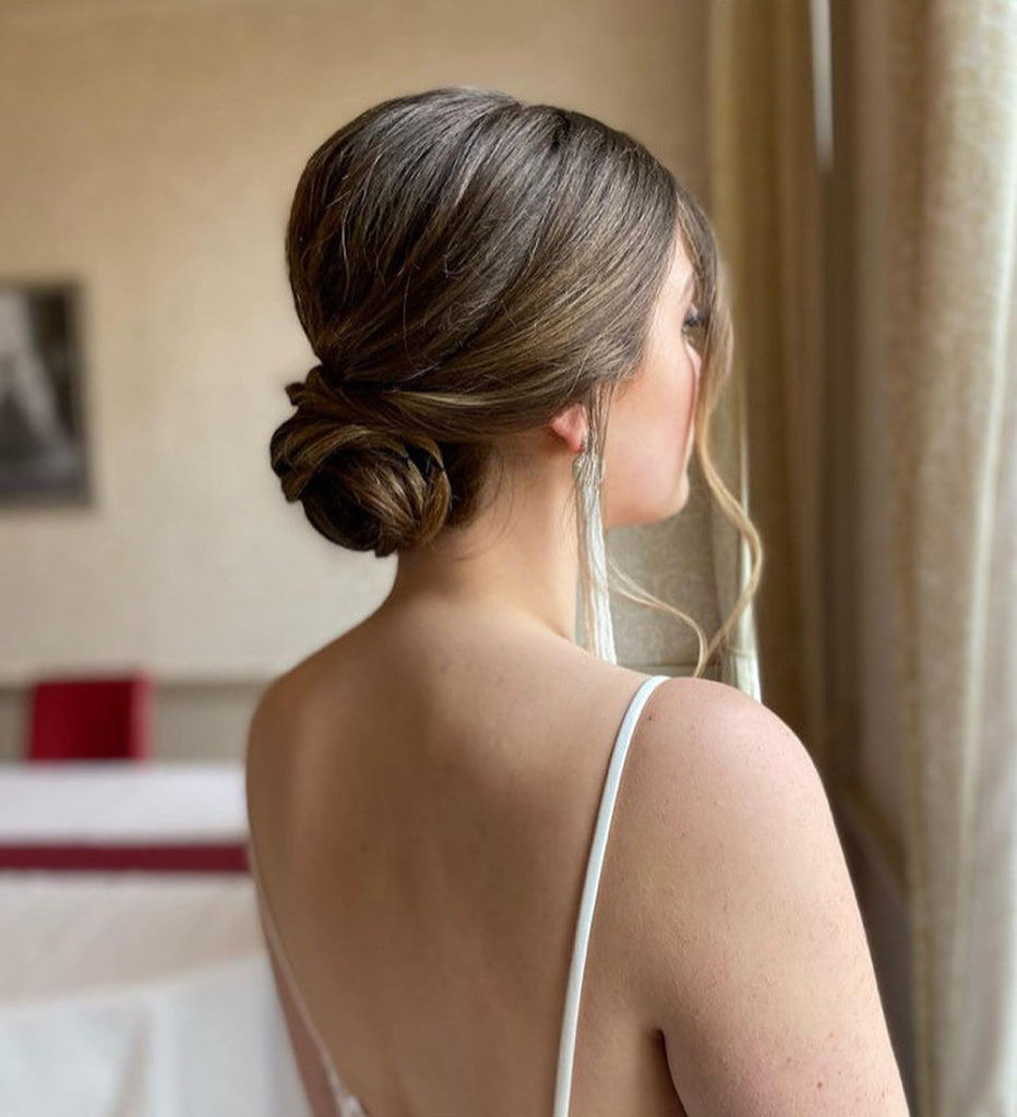 Sleek Dark Brown Bun with Face-Framing Sleek Dark Brown Bun with Face-Framing — Low Bun with Curtain Bangs