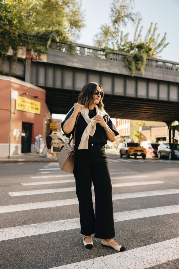 Monochromatic Ease: Black Wide Leg Jeans with Cream Sweater and Flats — Wide Leg Jeans Outfits
