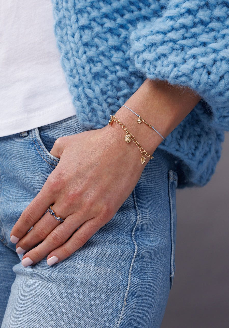 Oversized Cardigan and Jeans with a Multi-Charm Bracelet Oversized Cardigan and Jeans with a Multi-Charm Bracelet — Charm Bracelets