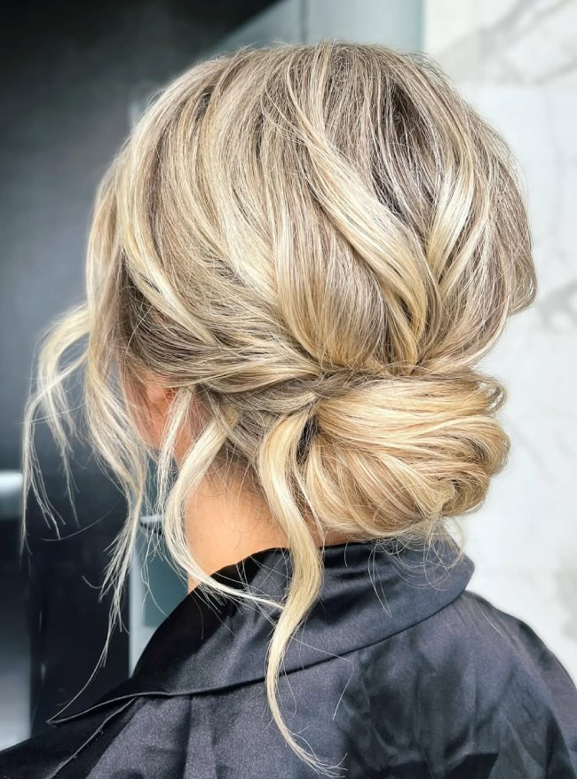 Mid-Back Length Textured Ash Blonde Bun with Tendrils Mid-Back Length Textured Ash Blonde Bun with Tendrils — Low Bun with Curtain Bangs