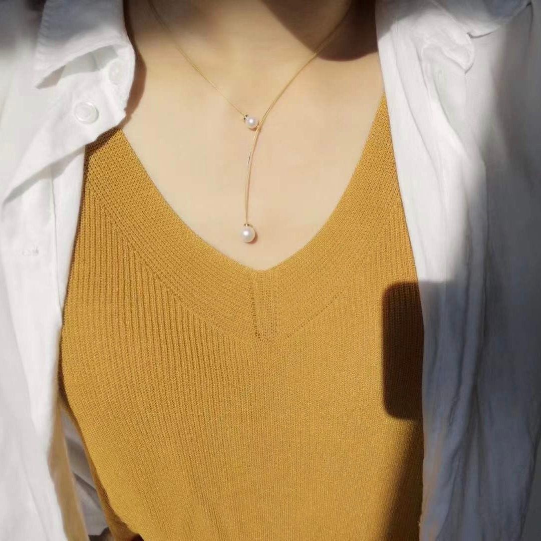 Delicate Pearl Pendant Layered Over Mustard Top and White Shirt Delicate Pearl Pendant Layered Over Mustard Top and White Shirt — Pearl Necklace Outfits