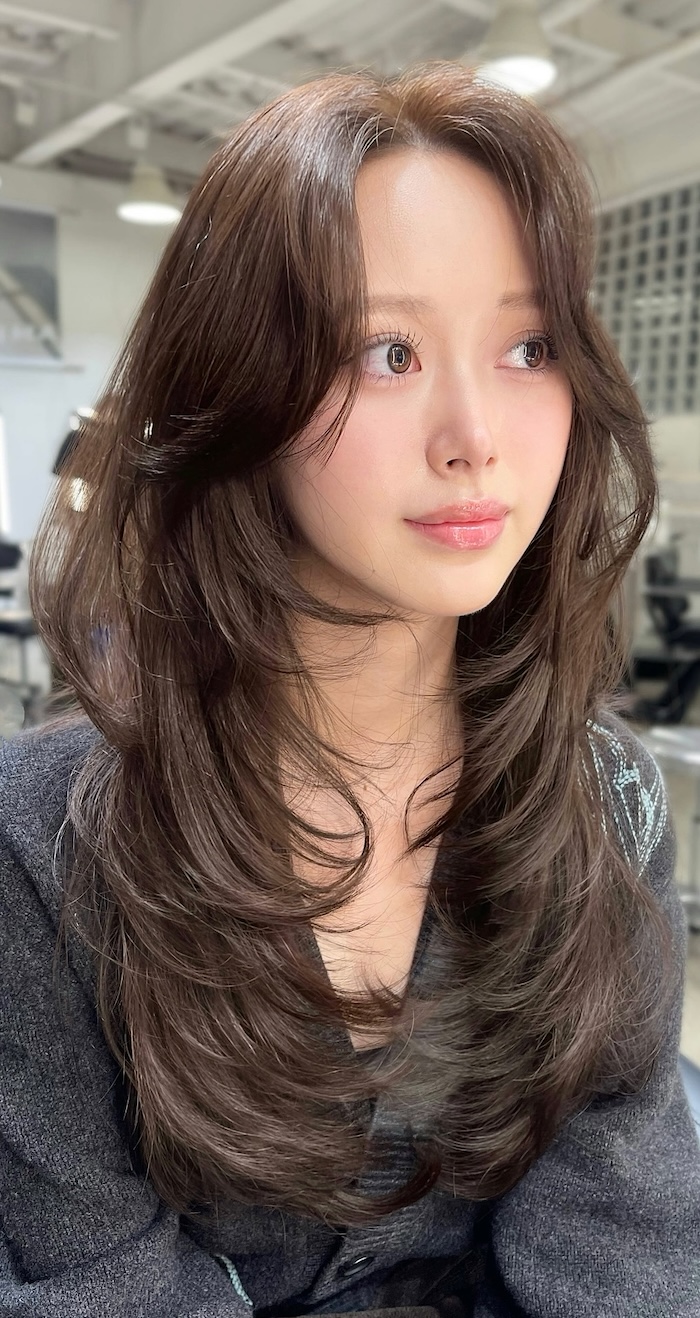 Textured Layers: Dark Top with a Grey Cardigan and Long Brown Bangs — Long Bangs