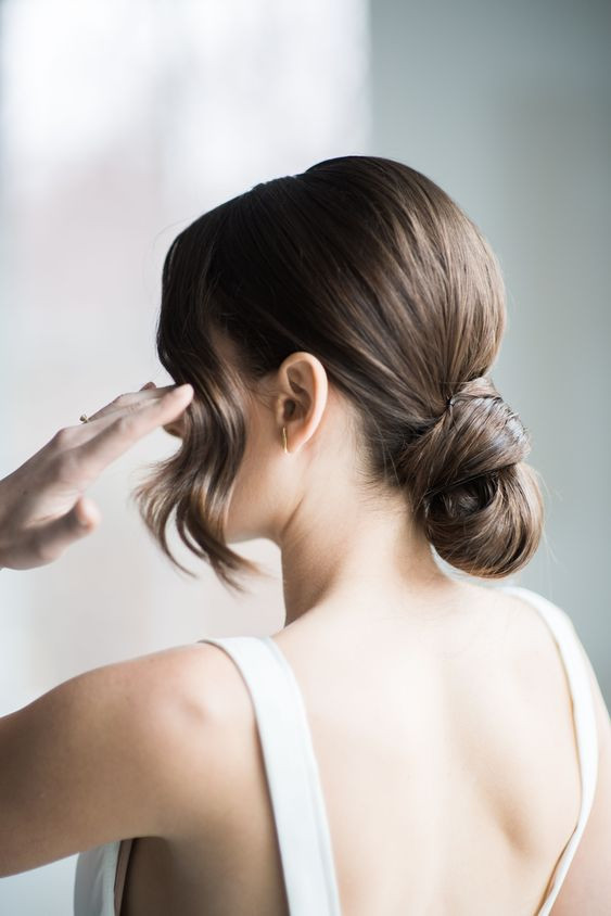 Wavy Dark Brown Bun with Side Bangs Wavy Dark Brown Bun with Side Bangs — Low Bun with Curtain Bangs