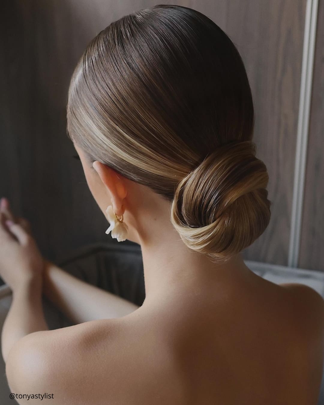 Polished Dark Blonde Low Bun With Subtle Highlights