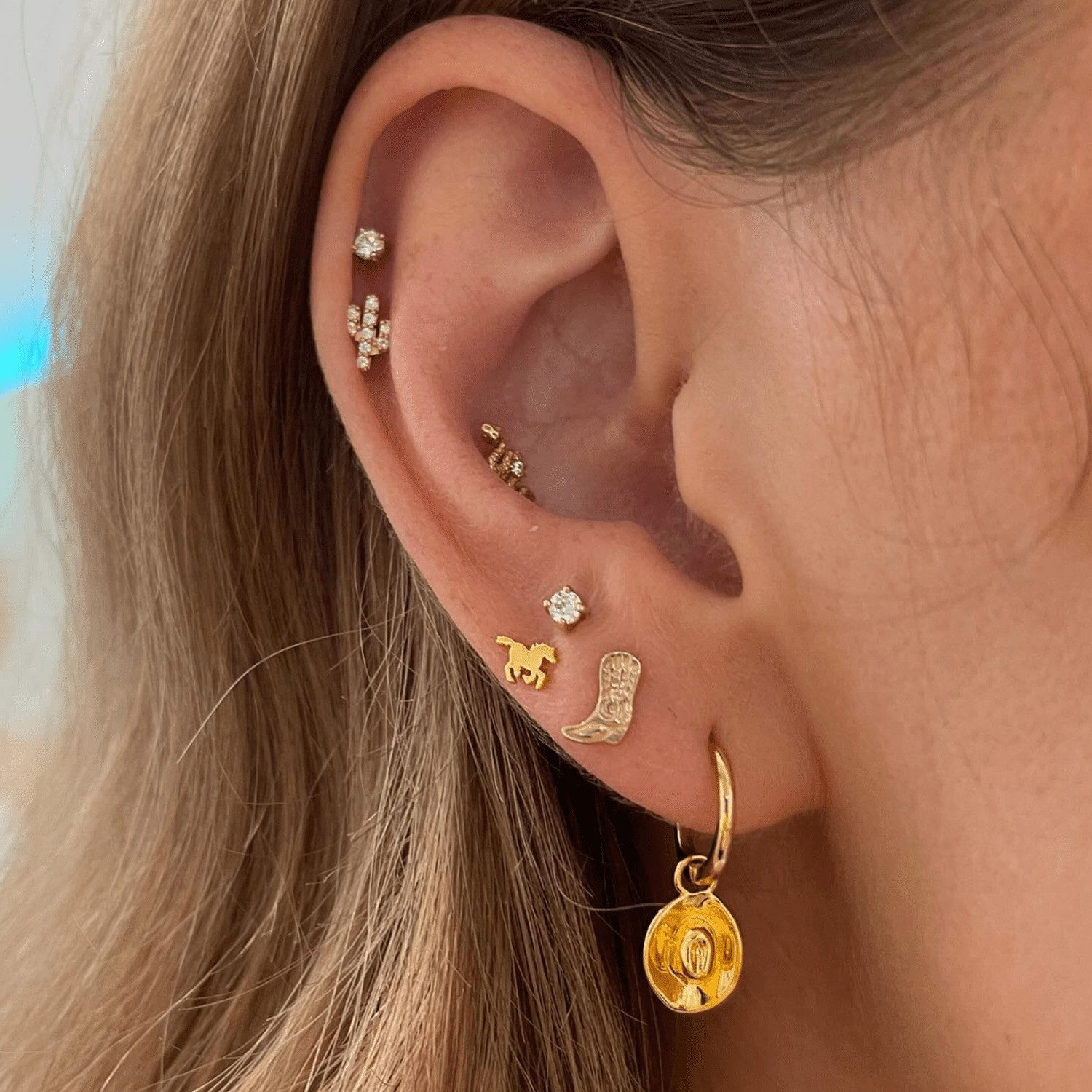 Playful Western-Themed Gold Ear Stack Playful Western-Themed Gold Ear Stack — Ear Stack Ideas