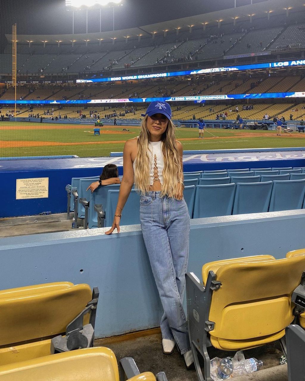 Lace-Up Crop Top with Flared Jeans and Pointed-Toe Boots — Baseball Game Outfits