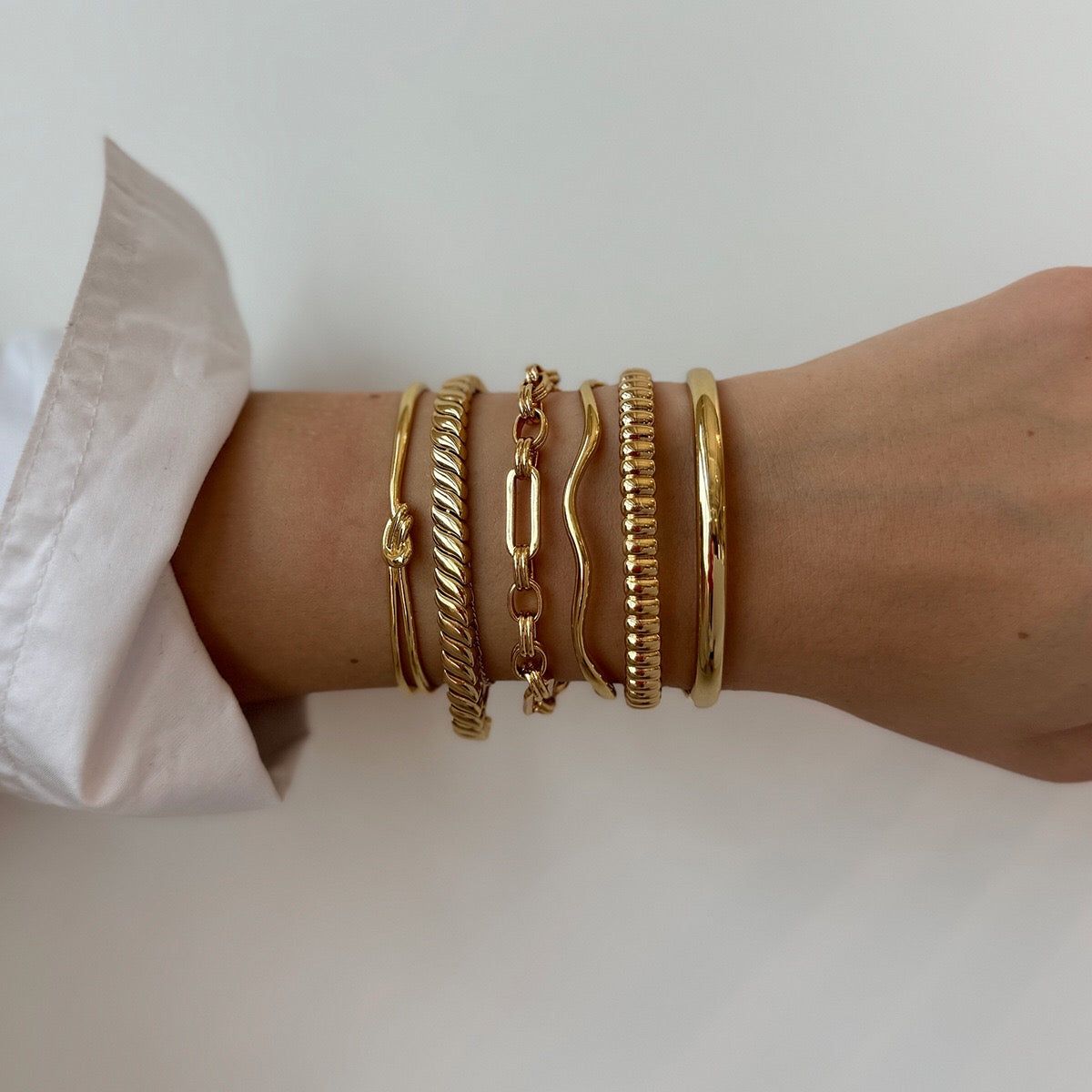 Varied Textures in a Gold Bangle Stack — Bangle Stacks