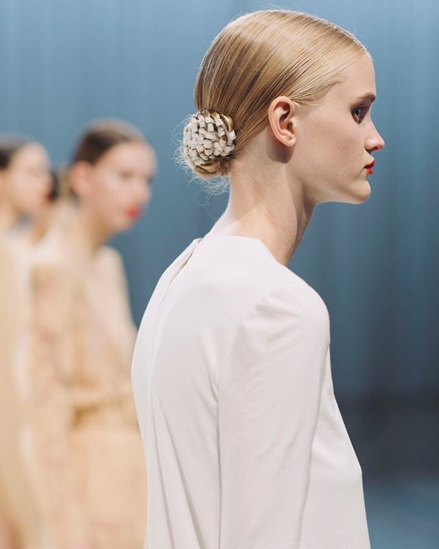 Platinum Blonde Low Bun With Floral Accessory Platinum Blonde Low Bun With Floral Accessory — Ballerina Bun
