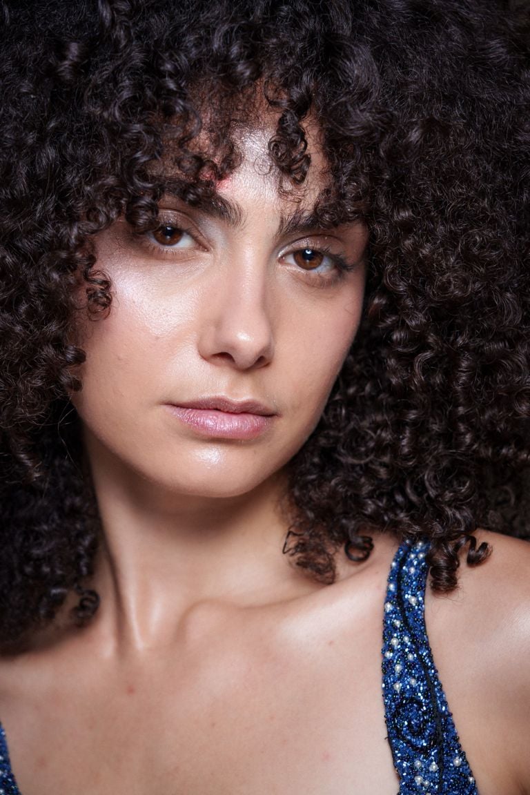 Close-Up Focus on Curly Bangs in Brown and Pink Tones Close-Up Focus on Curly Bangs in Brown and Pink Tones