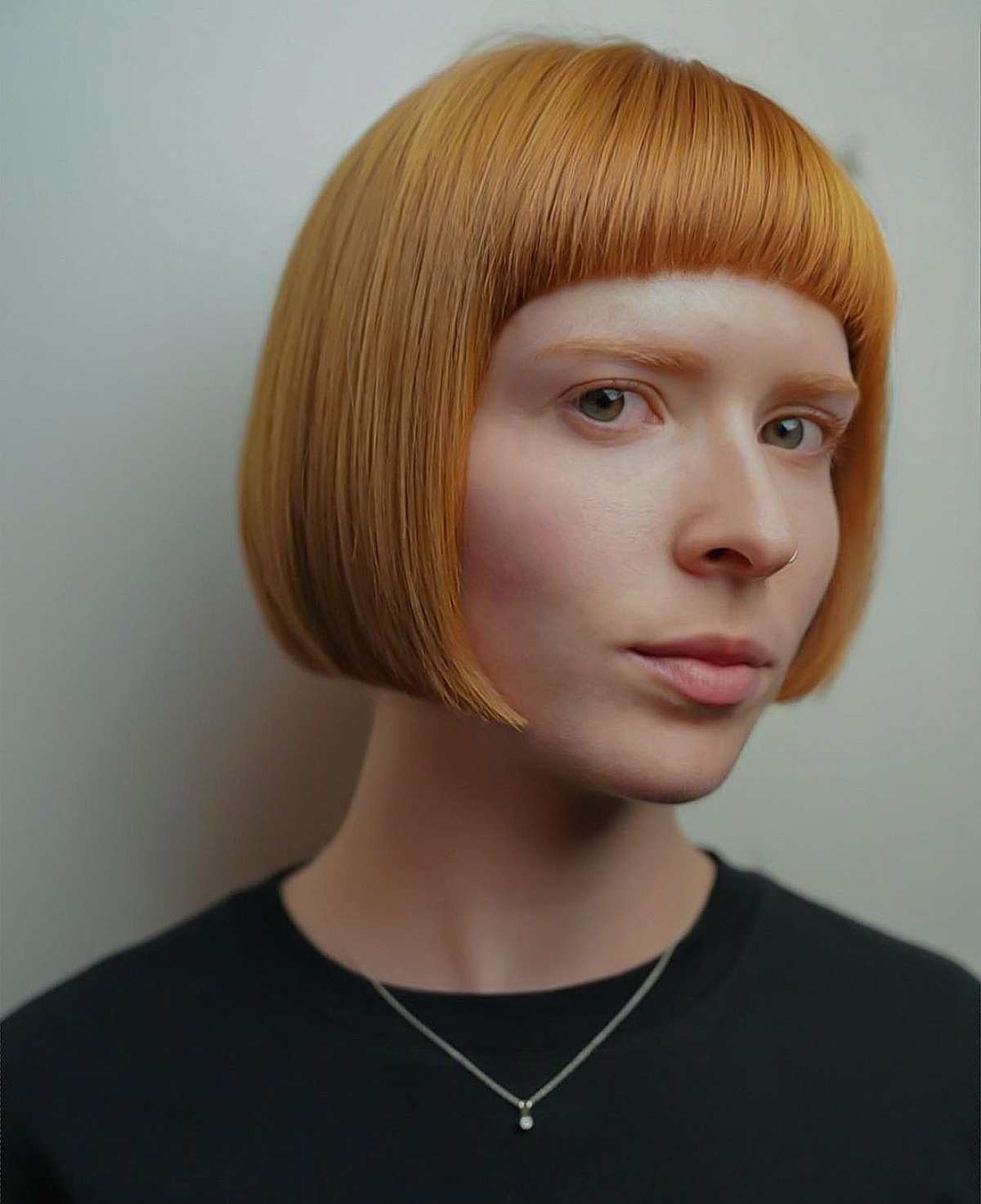 Orange Bowl Cut with Bangs and a Silver Pendant Necklace — Short Bangs