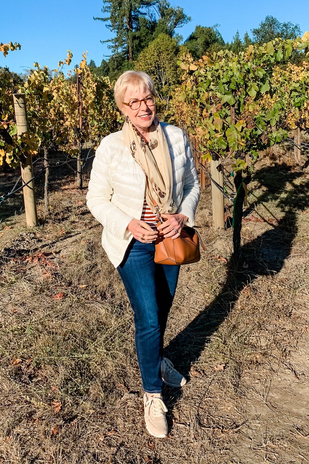 Puffer Jacket Over a Striped Top and Jeans for a Cozy Winery Visit — Winery Outfits