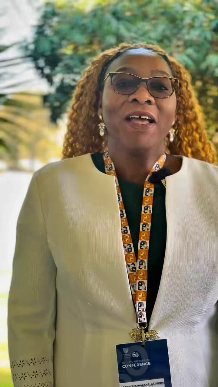 Cream Textured Blazer Layered Over a Dark Green Top with a Conference Lanyard Cream Textured Blazer Layered Over a Dark Green Top with a Conference Lanyard — Teacher Conference Outfits