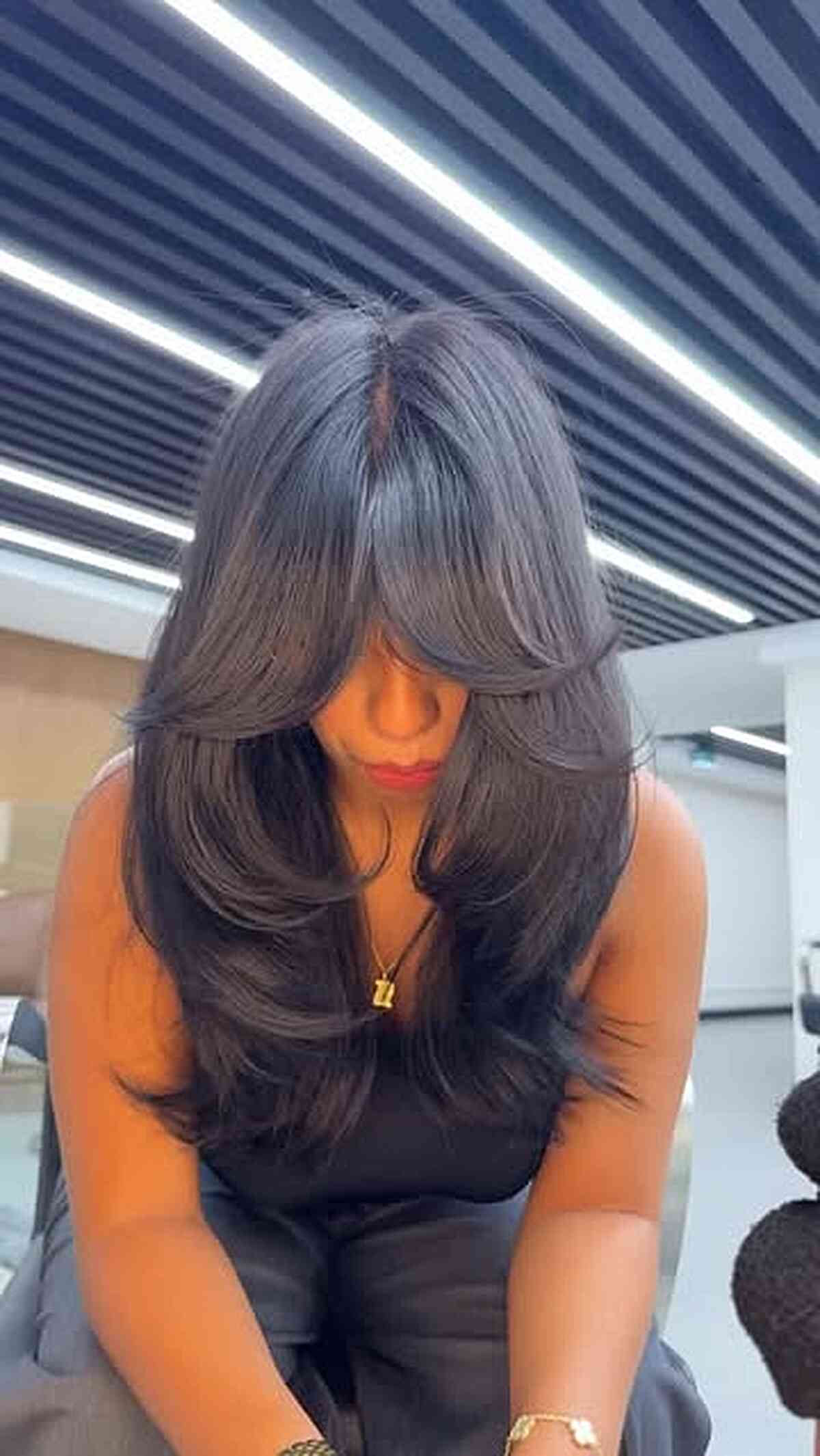 Polished Layers: Dark Brown Hair with Prominent Bangs and a Black Tank Top — Long Bangs
