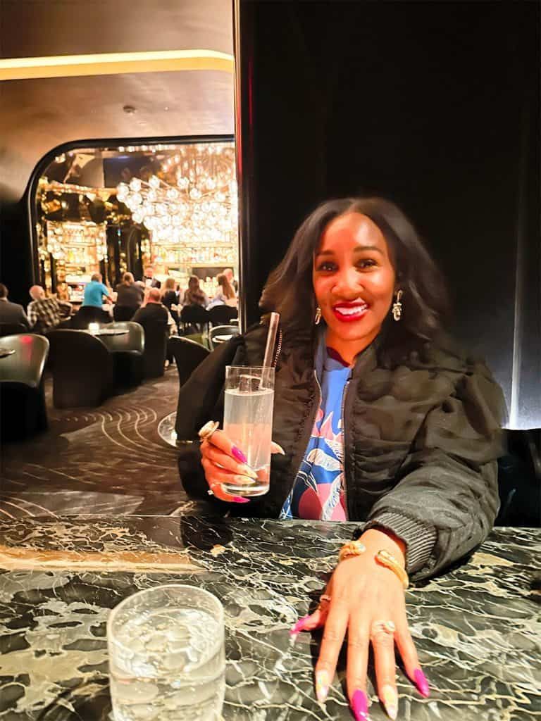 Black Bomber Jacket Over Graphic Top for Vegas Club — Vegas Club Outfits