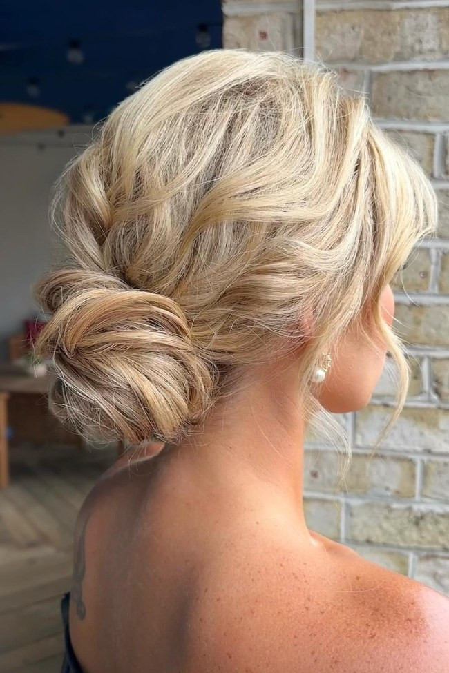 Medium-Back Textured Blonde Bun with Face-Framing Medium-Back Textured Blonde Bun with Face-Framing — Low Bun with Curtain Bangs