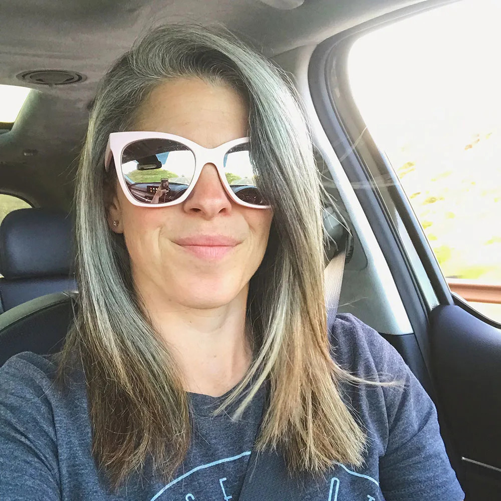 Wavy Mid-Back Layers With Gray Roots — Transitioning to Gray Hair