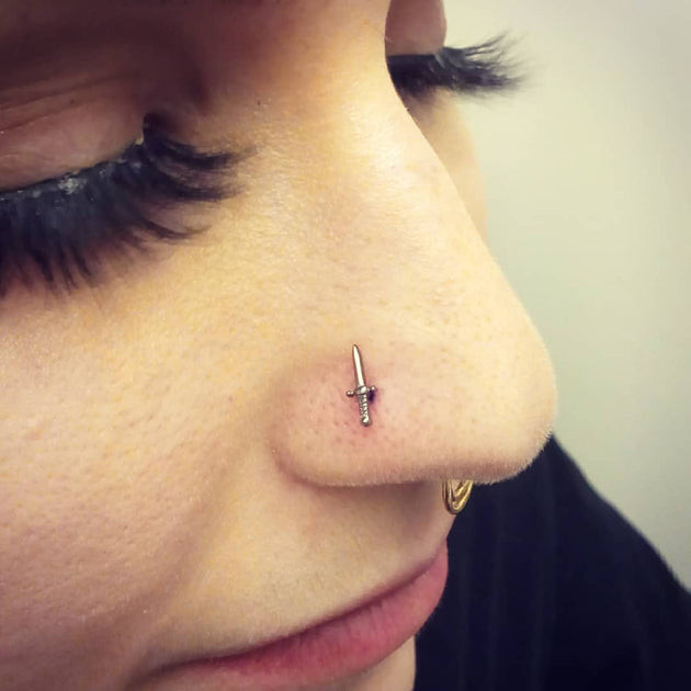Unique Sword-Shaped Stud and Gold Hoop Combination Unique Sword-Shaped Stud and Gold Hoop Combination — Nose Piercing Ideas